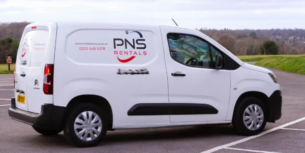 A white van with the pns rentals logo on it.