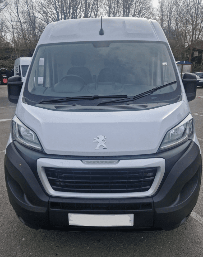 A van parked in the parking lot of a building.