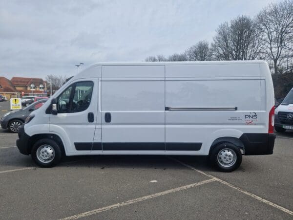 A white van parked in the parking lot.