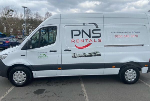 A white van with the pns rentals logo on it.