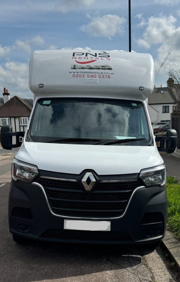 A white van parked on the side of a road.