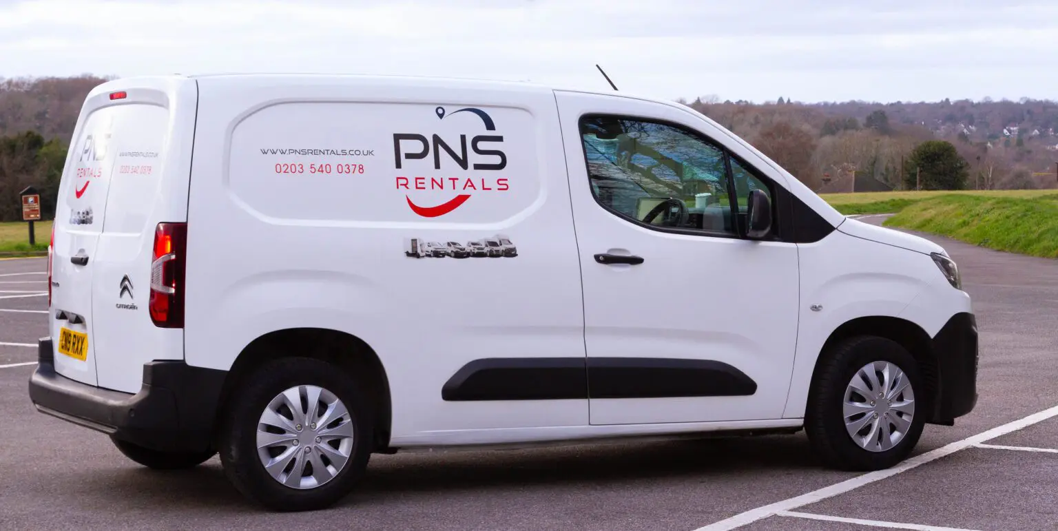 A white van with the pns rental logo on it.