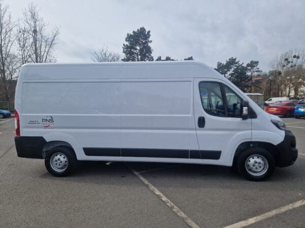 A white van parked in the parking lot.